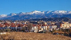 View of Peligros town with snow-capped mountains in the background