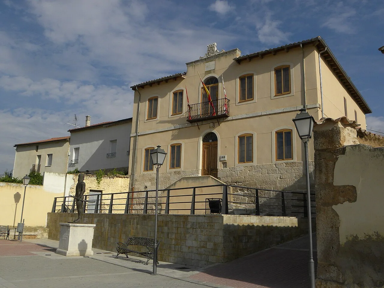 Town hall building with balcony and flags in Castrillo de Duero.