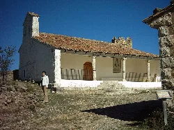 Stone chapel with tiled roof and columns in San Agustín, Teruel.